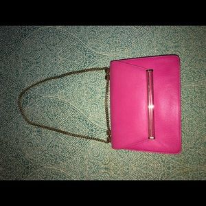Pink medium size purse with gold chain strap.